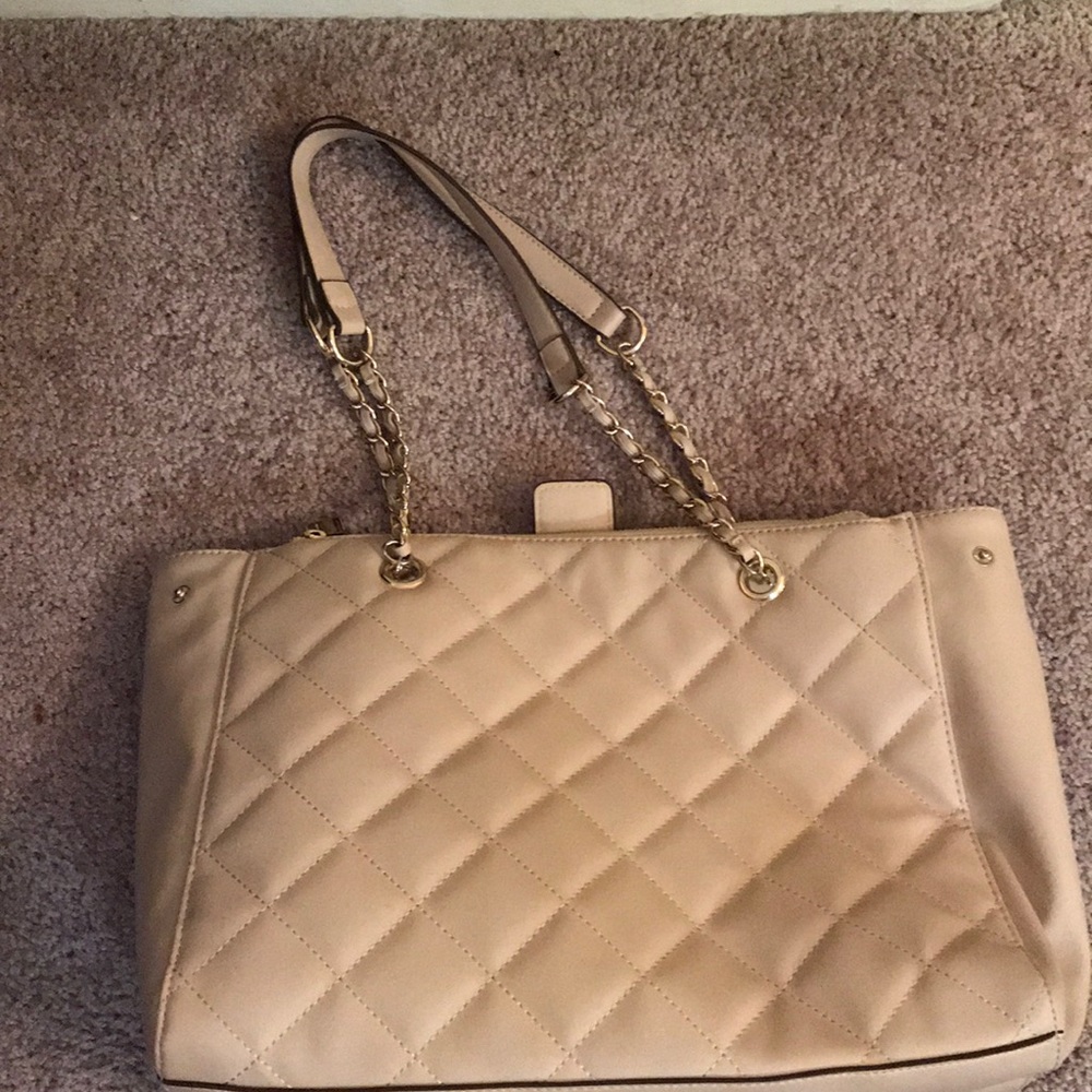Cream colored quilted bag.
